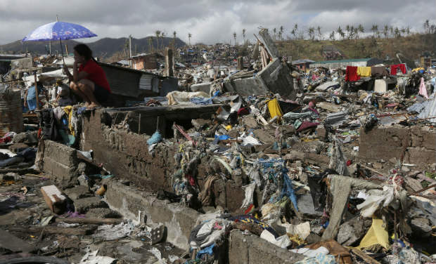 A survivor sits among debris in the typhoon ravaged city of Tacloban, Leyte province, central Philippines on Wednesday. -AP A survivor sits among debris in the typhoon ravaged city of Tacloban, Leyte province, central Philippines on Wednesday. -AP
